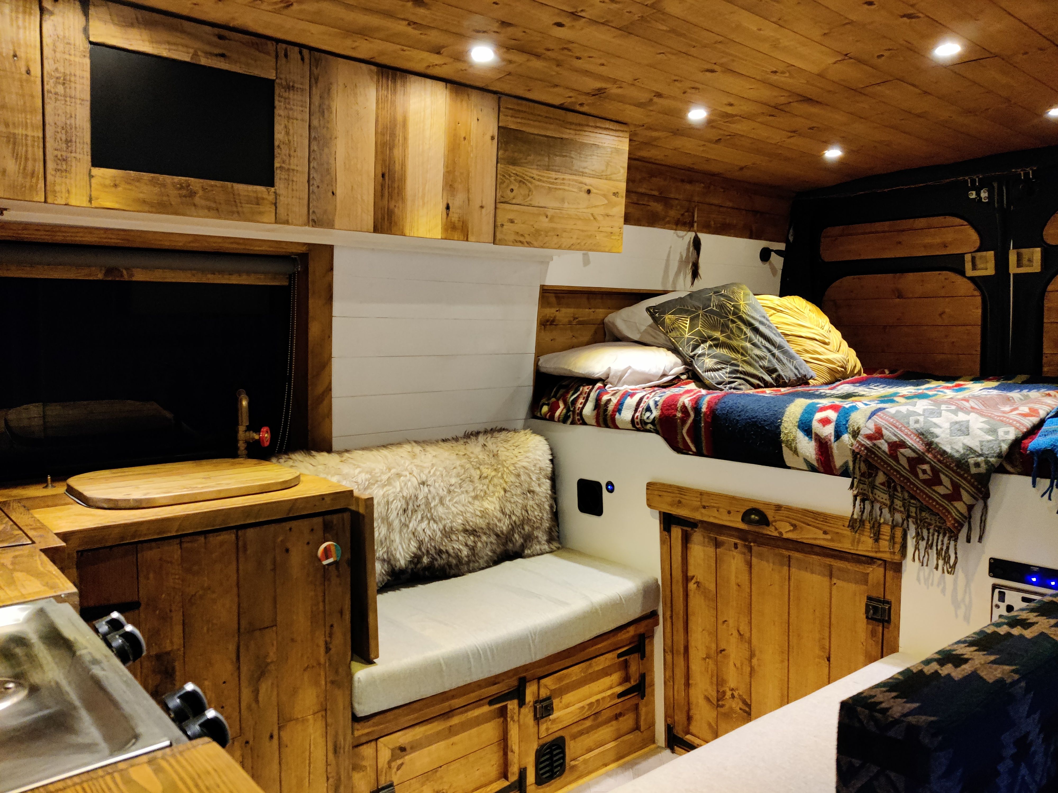 Custom fitted campervan kitchen in natural materials