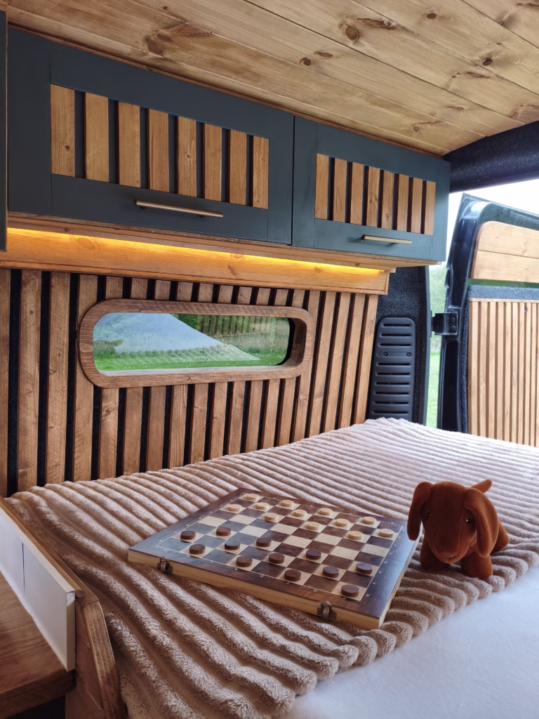 Cosy fixed double bed with reclaimed wood panelling
